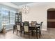 Elegant dining room showcasing a chandelier, large window, a china cabinet, and seating for six at 1382 Heritage Landings Dr, Lakeland, FL 33805