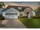 Charming home featuring a stone archway, manicured lawn, and a two-car garage at 1382 Heritage Landings Dr, Lakeland, FL 33805