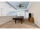 Upstairs game room featuring a pool table, tv, neutral carpeting, and a blue tray ceiling with ceiling fan at 1382 Heritage Landings Dr, Lakeland, FL 33805