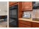 Bright kitchen featuring stainless steel appliances, brown cabinets, and light countertops with diamond-patterned tile backsplash at 1382 Heritage Landings Dr, Lakeland, FL 33805