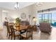 Open-concept living and dining area with tile floors, large windows, comfortable seating, and water view at 1382 Heritage Landings Dr, Lakeland, FL 33805