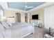 Airy bedroom with a pastel blue ceiling, two dressers, and a chair beneath a bright window at 1382 Heritage Landings Dr, Lakeland, FL 33805