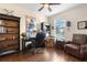 Office featuring a dark wood desk, built in shelves, leather chair, and neutral paint at 1382 Heritage Landings Dr, Lakeland, FL 33805