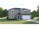 Charming two-story home with well-maintained lawn and attached two car garage at 1502 Landon Ln, Haines City, FL 33844