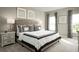 Serene bedroom with a tufted headboard, stylish decor, and abundant natural light from the large window at 1538 Landon Ln, Haines City, FL 33844