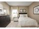 Bright bedroom featuring neutral walls, a bed, and a mirrored nightstand offering a serene retreat at 1538 Landon Ln, Haines City, FL 33844