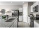 Modern kitchen with stainless steel appliances, granite countertops, and white cabinetry at 1538 Landon Ln, Haines City, FL 33844