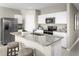 Bright kitchen features stainless steel appliances, granite countertops, and a convenient island with seating at 1538 Landon Ln, Haines City, FL 33844