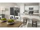 Stylish kitchen with stainless appliances, granite counters, and a breakfast bar that opens to the dining area at 1538 Landon Ln, Haines City, FL 33844