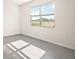 Bright bedroom featuring neutral walls, a large window, and light-colored flooring at 4106 Nw 44 Cir, Ocala, FL 34482
