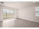 Bright and spacious living room with tile floors and large windows, leading to outdoor views at 4106 Nw 44 Cir, Ocala, FL 34482