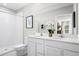 Bright bathroom featuring a double sink vanity, shower, and framed art at 420 Harvard Ct, Dundee, FL 33838