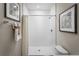 Bathroom featuring a white tile shower, framed artwork, and neutral wall color at 420 Harvard Ct, Dundee, FL 33838