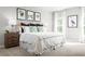 Bedroom featuring a bed with white linens, botanical wall art and a window with natural light at 420 Harvard Ct, Dundee, FL 33838