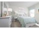 Bright bedroom featuring pastel decor, a white dresser, and a window with striped valance at 420 Harvard Ct, Dundee, FL 33838