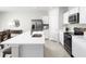 Bright kitchen featuring white cabinets, stainless steel appliances, and a spacious quartz countertop island at 420 Harvard Ct, Dundee, FL 33838
