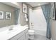 A bathroom featuring a shower-tub combo, toilet, sink, and a decorative mirror at 480 Crossings Ave, St Cloud, FL 34771
