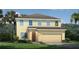 Charming two-story home with a manicured lawn and attached two-car garage in a tropical location at 480 Crossings Ave, St Cloud, FL 34771