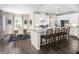 Modern kitchen features a granite-top island with seating, stainless steel appliances, and white cabinetry at 480 Crossings Ave, St Cloud, FL 34771