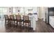 Modern kitchen features a granite-top island with seating, stainless steel appliances, and white cabinetry at 480 Crossings Ave, St Cloud, FL 34771