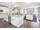 Open-concept kitchen with an island that flows into the living area, featuring stainless steel appliances at 480 Crossings Ave, St Cloud, FL 34771