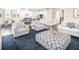 Spacious living room with cozy seating, a modern patterned ottoman, and open access to the kitchen at 480 Crossings Ave, St Cloud, FL 34771