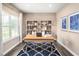 Well-lit office space with a large window, stylish decor, and a blue patterned rug at 480 Crossings Ave, St Cloud, FL 34771