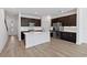 Contemporary kitchen with stainless appliances, an island, and dark wood cabinetry at 1126 Desert Candle Dr, Ocoee, FL 34761