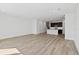 Open-concept living room with light wood floors and an adjoining modern kitchen at 1126 Desert Candle Dr, Ocoee, FL 34761