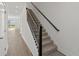 Carpeted staircase with black metal railings, leading to the upper floor of the home at 1126 Desert Candle Dr, Ocoee, FL 34761