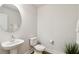 Stylish half-bathroom featuring a modern vanity, round mirror, and elegant fixtures for guests' convenience at 3307 Grande Heron Dr, St Cloud, FL 34773