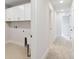 Hallway with tile flooring, modern lighting, and white cabinets creating a serene and functional area at 3307 Grande Heron Dr, St Cloud, FL 34773