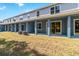 A covered back patio with air conditioning units sits off of an outdoor lawn at 5240 Luisa Ct, St Cloud, FL 34771