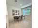 Cozy dining area features a modern table, comfortable chairs, natural light, and stylish wall decor at 5240 Luisa Ct, St Cloud, FL 34771