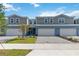 Well-manicured townhomes with two-car garages, manicured landscaping, and paver driveways at 5240 Luisa Ct, St Cloud, FL 34771