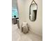 Hallway corner featuring decorative mirror, stylish throw blanket, and is adjacent to the kitchen and bathroom at 5240 Luisa Ct, St Cloud, FL 34771