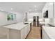 A bright kitchen with white cabinetry, stainless steel appliances, and a large island with a sink at 5240 Luisa Ct, St Cloud, FL 34771