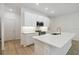 A bright kitchen with an island, stainless steel appliances, and modern white cabinets at 5240 Luisa Ct, St Cloud, FL 34771