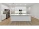 A modern, all white kitchen with a large island and stainless steel appliances at 5240 Luisa Ct, St Cloud, FL 34771