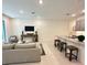 Inviting living room is complete with stylish furniture, modern lighting, and flows into the open kitchen area at 5240 Luisa Ct, St Cloud, FL 34771