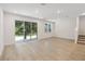 Bright living room featuring light wood floors, recessed lighting, and sliding glass doors to the backyard at 5240 Luisa Ct, St Cloud, FL 34771