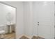Stylish powder room with pedestal sink, modern fixtures, and wood-look tile flooring at 5240 Luisa Ct, St Cloud, FL 34771