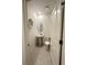 Chic powder room features a pedestal sink, decorative seashell, and modern fixtures in a clean, minimalist design at 5240 Luisa Ct, St Cloud, FL 34771