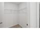 A simple walk-in closet with wire shelving and neutral carpet is perfect for organizing clothes and accessories at 5240 Luisa Ct, St Cloud, FL 34771