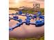 Floating aquapark on the water with slides, climbing structures and obstacles under a clear sky at 5269 Luisa Ct, St Cloud, FL 34771