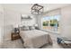 Bright bedroom with a large window, stylish decor, and a comfortable bed with decorative pillows at 5269 Luisa Ct, St Cloud, FL 34771