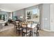 Bright dining room with a wooden table, seating for six, and large windows offering views of the outdoors at 5269 Luisa Ct, St Cloud, FL 34771