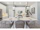 The kitchen features pendant lights, a spacious island with seating, and modern stainless steel appliances at 5269 Luisa Ct, St Cloud, FL 34771