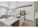 Modern kitchen features stainless steel appliances, a large island with seating, and ample counter space at 5269 Luisa Ct, St Cloud, FL 34771