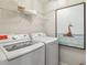 Efficient laundry room featuring a white washer and dryer set and an artful giraffe picture at 5269 Luisa Ct, St Cloud, FL 34771